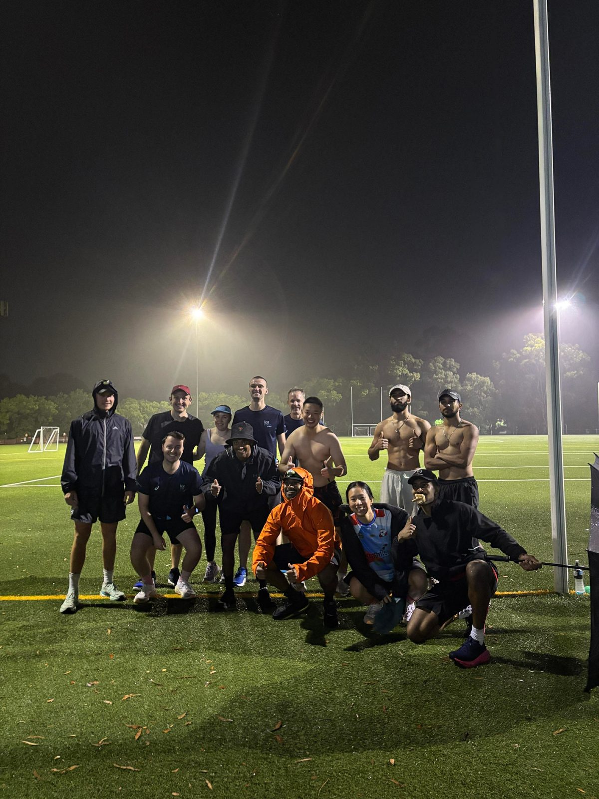Participants gathered under floodlights at night
